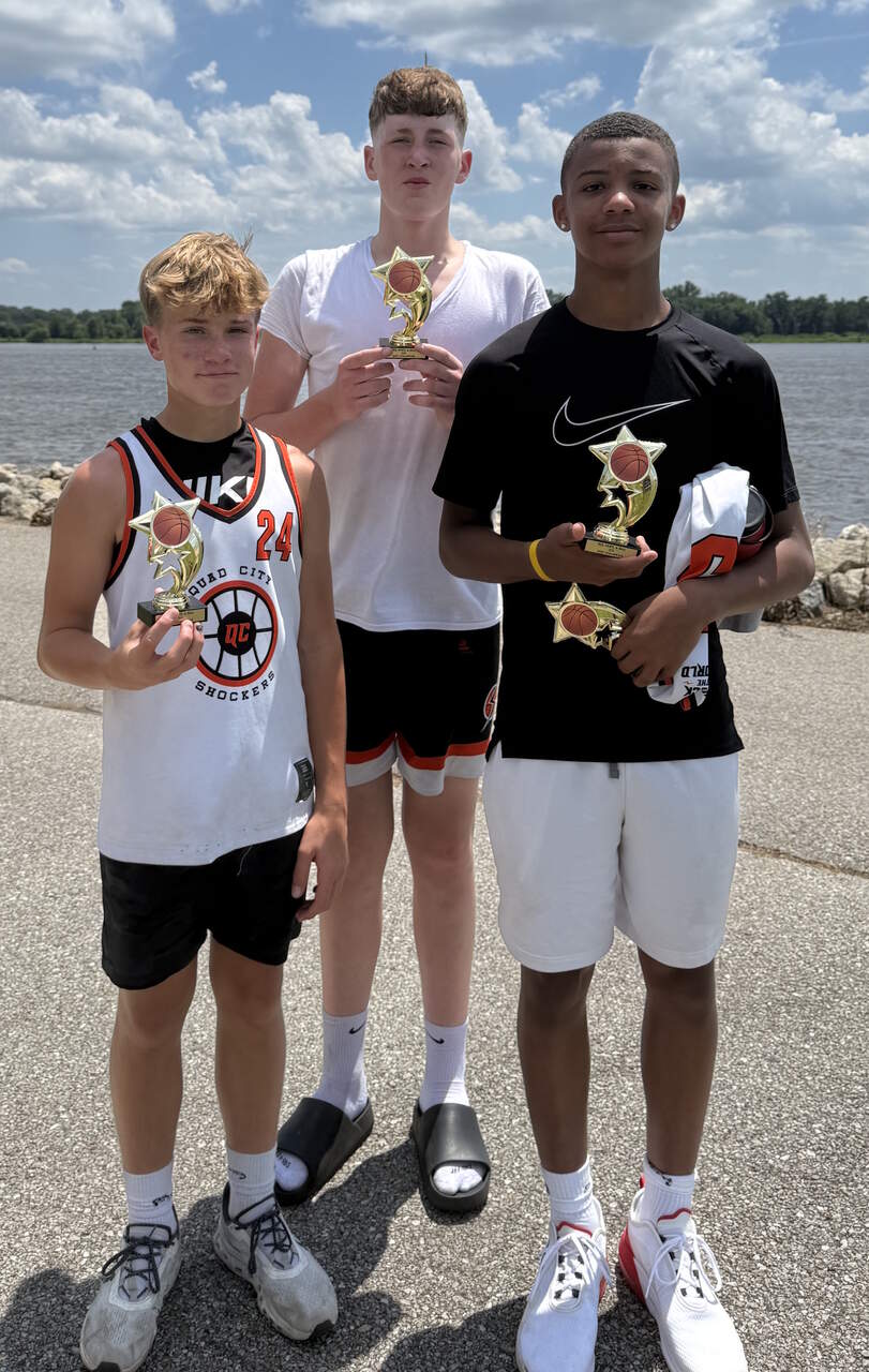 Boys holding trophies on the Muscatine riverfront